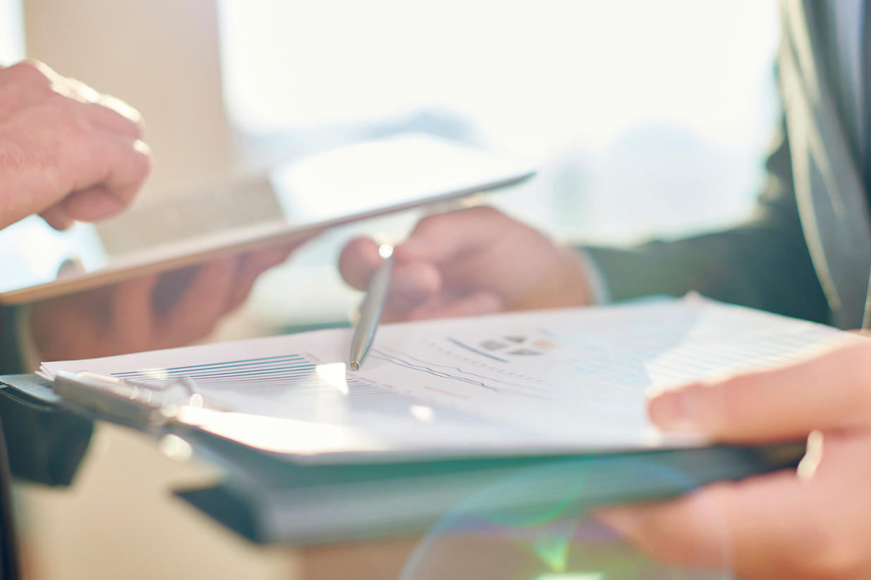 A pen pointing at paper